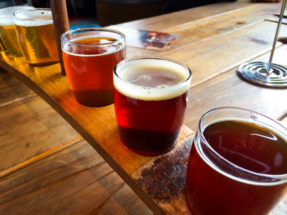 A flight of craft beers on a table. | Kia  Dealer in Conway, AR.