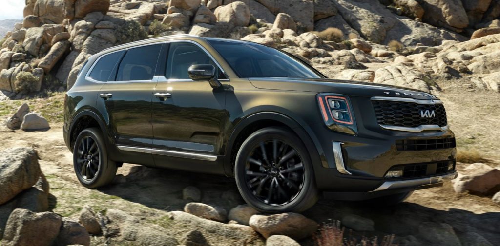 An army green 2022 Kia Telluride parked on rocky terrain. | Kia Dealer in Conway, AR.