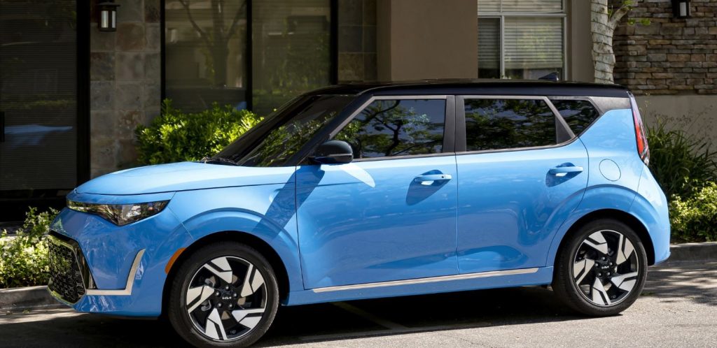 Profile view of a light blue 2023 Kia Soul parked on a curb. | Kia dealer in Conway, AR.