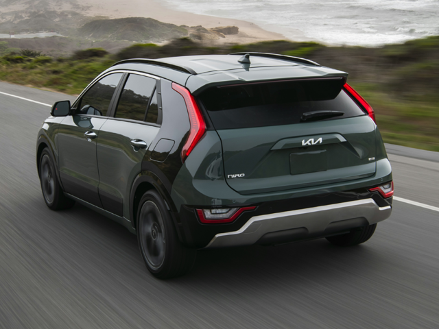 A dark greyish green 2023 Kia Niro being driven on the highway. | Kia dealer in Conway, AR | Crain Kia of Conway