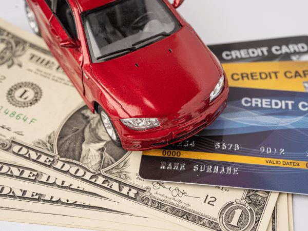 Toy car on credit cards and dollar bills